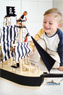 Junge spielt mit Spiel-Segelschiff aus Holz